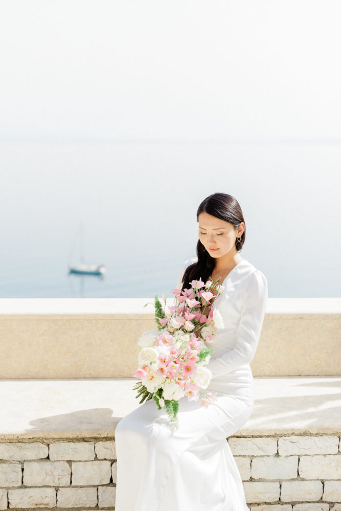 Stunning bride holding this elegant wedding bouquet while enjoy the vie of Corfu island