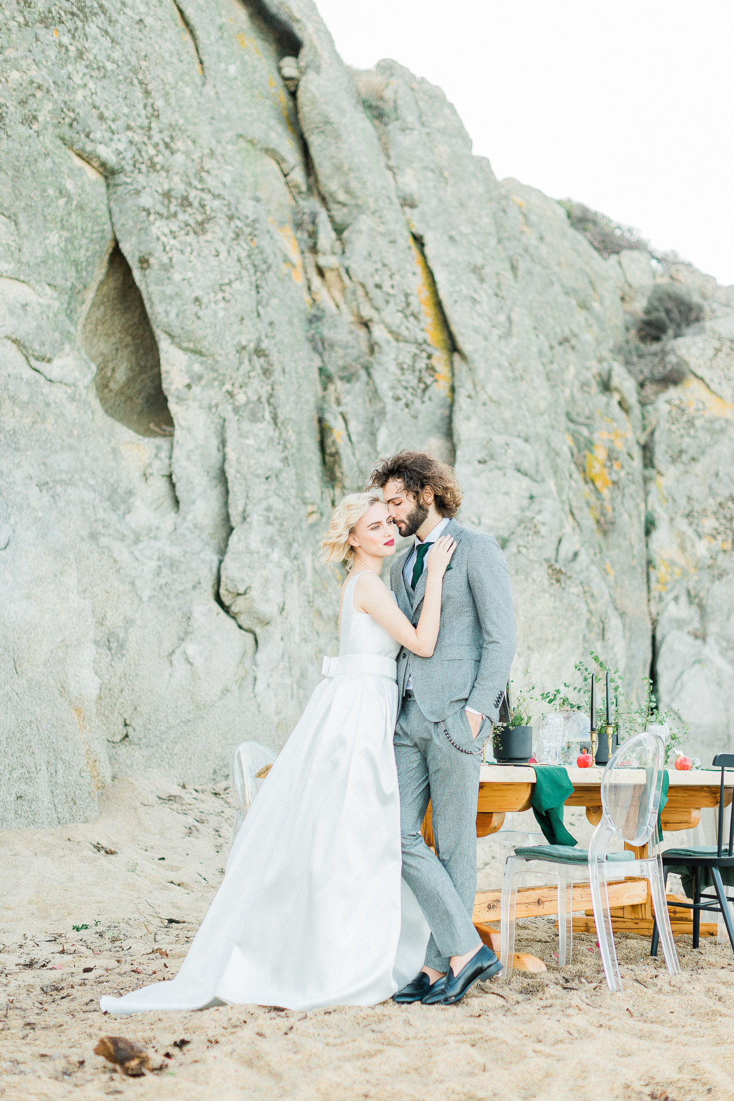 a romantic couple portrait on a rocky beach elopement at in Greece