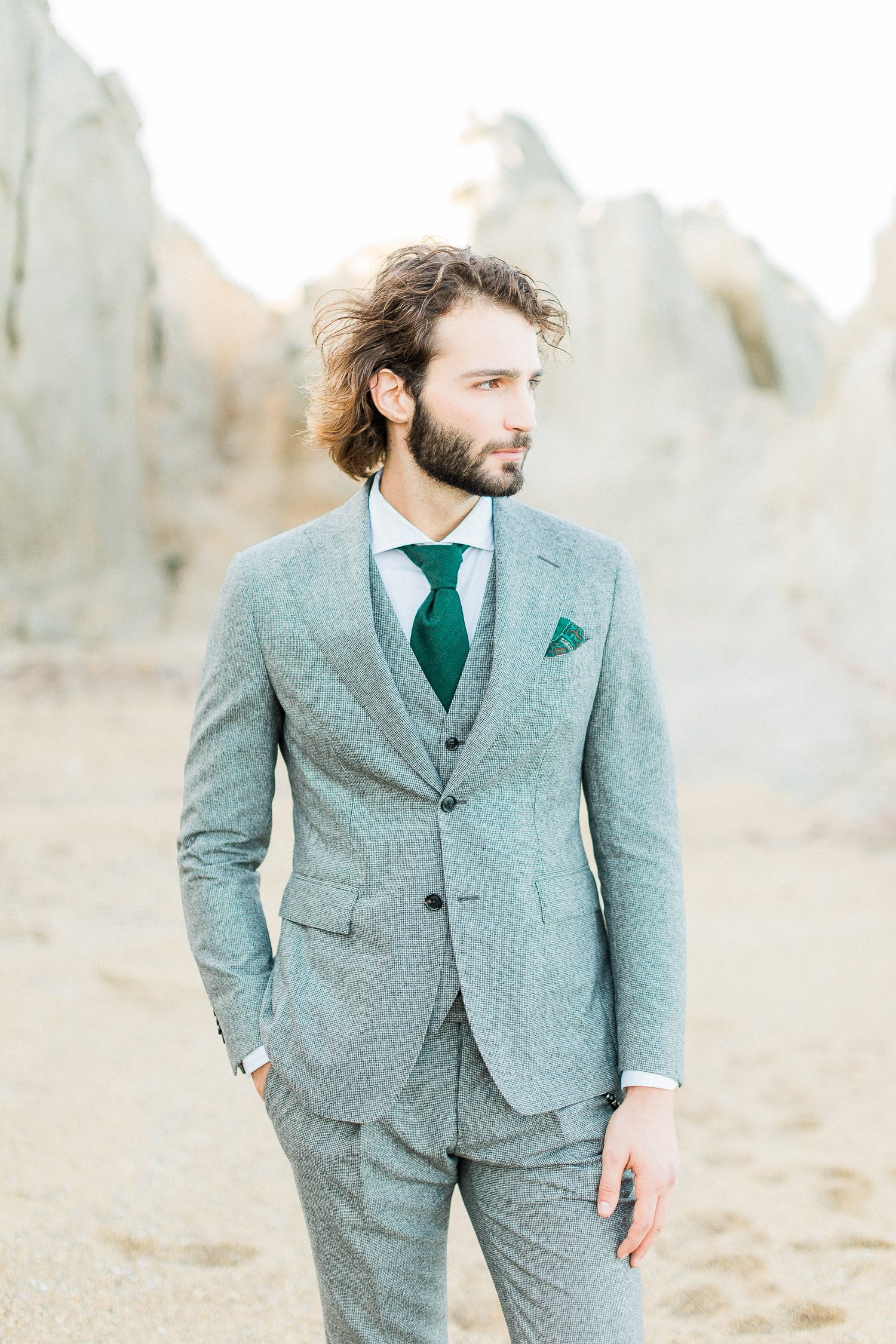 groom's portrait wearing a grey tuxedo