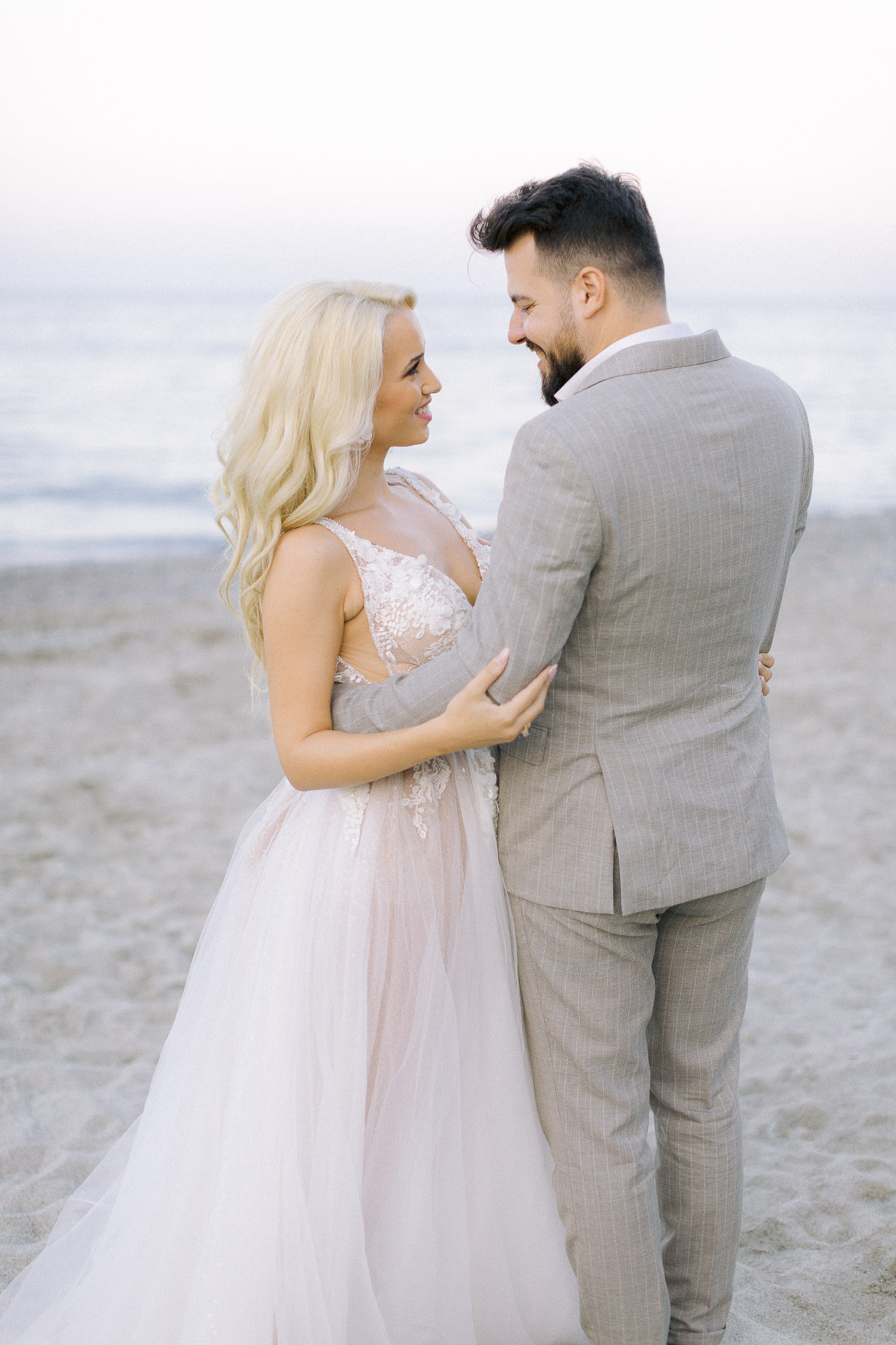Romantic coastal wedding bride and groom portrait on the beach