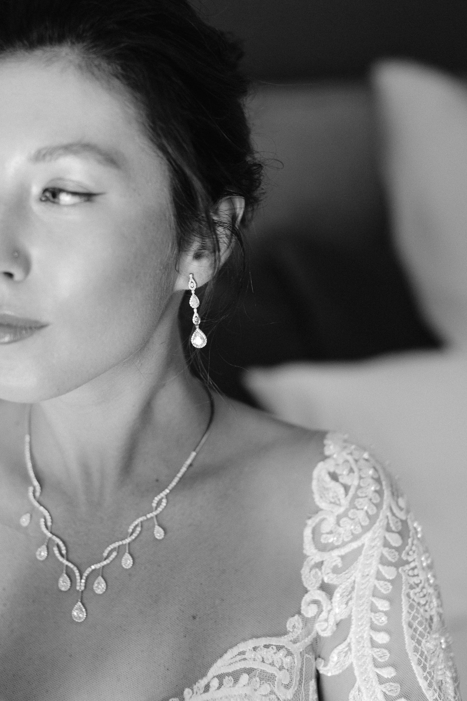 Close up bridal portrait wearing her diamond earrings 