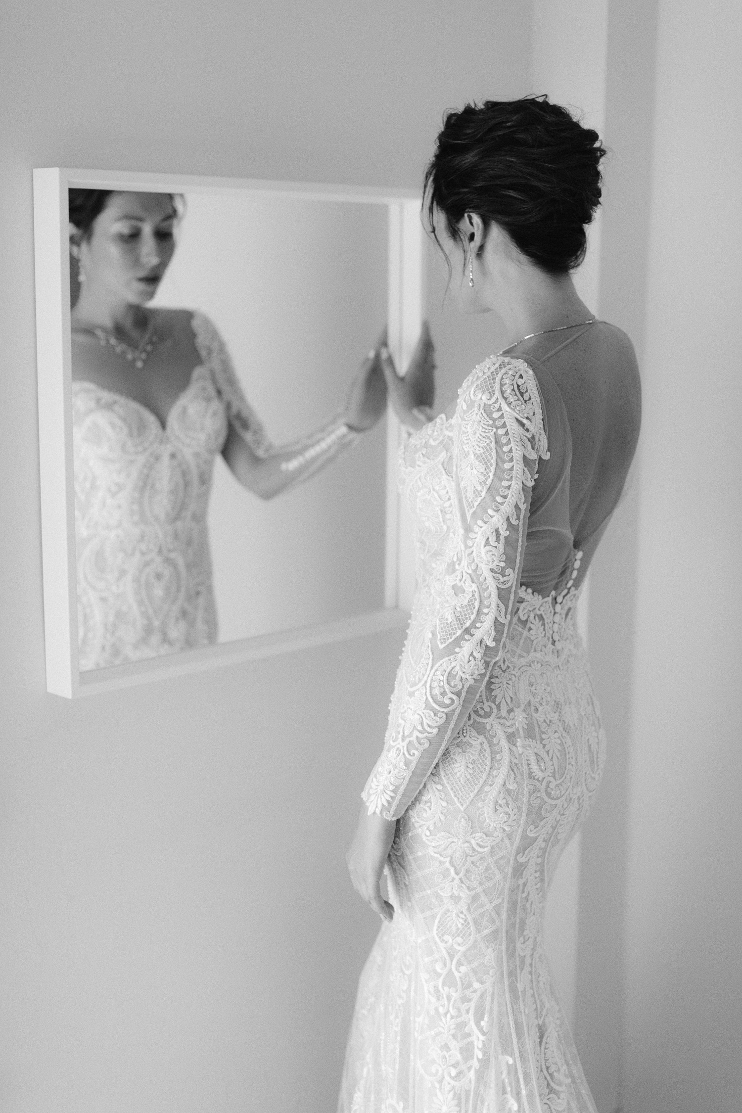 Fashion bridal portrait in front of bridal luxury suite mirror 