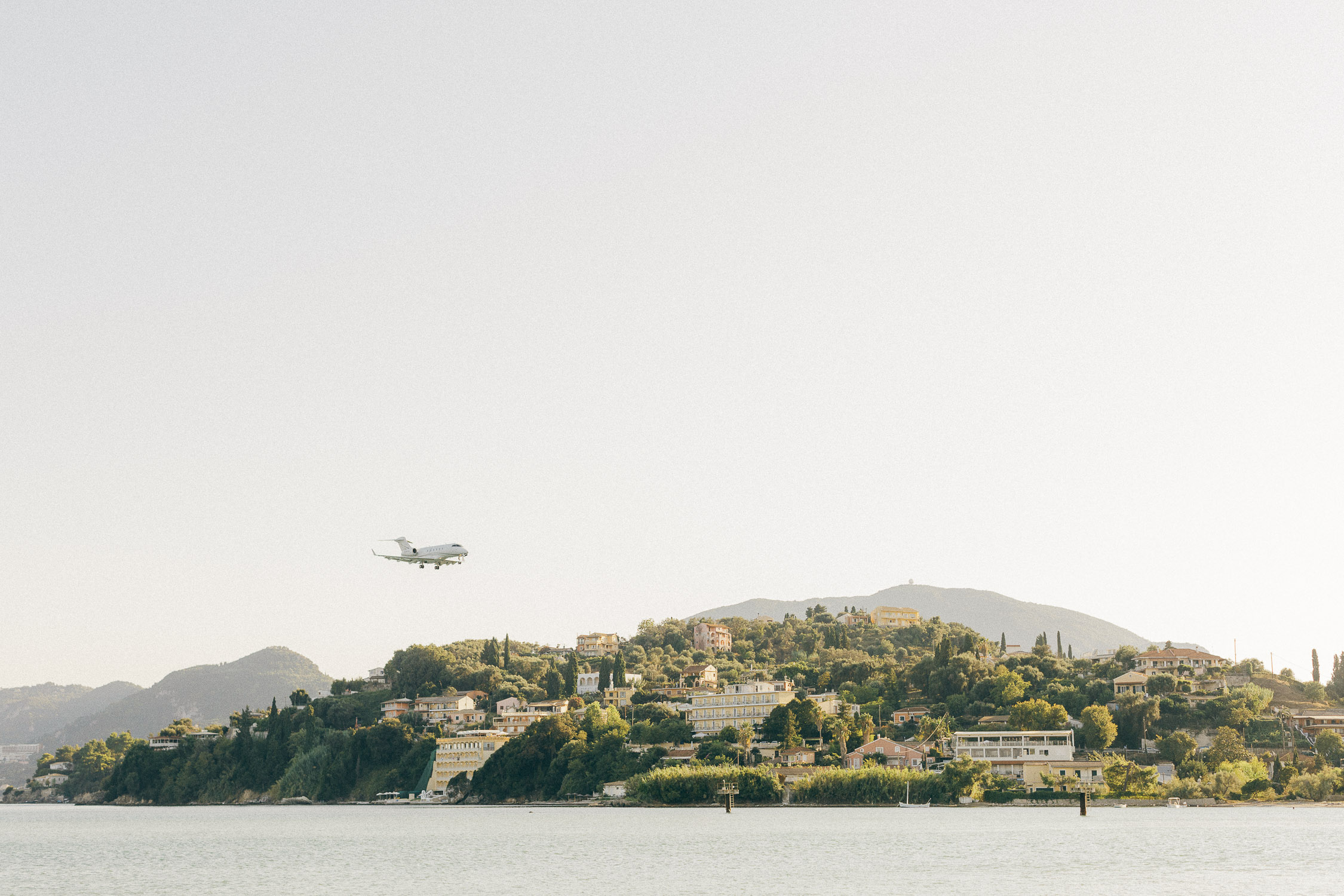 Corfu landscape near to Pontikonisi island while private jet landing
